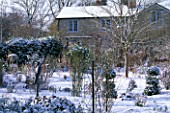 VIEW FROM THE GARDEN TO THE HOUSE IN SNOW. WOODCHIPPINGS  NORTHAMPTONSHIRE. DECEMBER