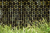 WALL MADE FROM STEEL GABIONS FILLED WITH BOTTLES. DESIGN BY SCENIC BLUE  CHELSEA 2005