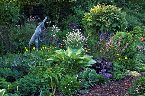 WOODCHIPPINGS__NORTHANTS_THE_OLD_ORCHARD_IN_SPRING_WITH_STATUE_AND_HOSTA_WOODLAND__SHADE__SHADY
