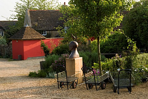 WINGWELL_NURSERY___RUTLAND_THE_NURSERY_AREA_WITH_BIRD_MAN_SCULPTURE_BY_CHRIS_MARVELL_AND_RED_WALL