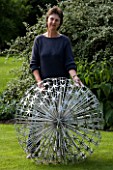 ROSE DEJARDIN ON THE LAWN WITH ALLIUM  A SCULPTURE BY RUTH MOILLIET. WINGWELL NURSERY   RUTLAND