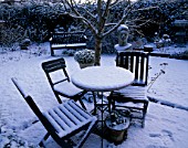 WINTER  WOODCHIPPINGS  NORTHAMPTONSHIRE: TABLE AND CHAIRS IN SNOW