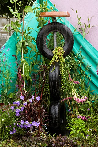 DESIGNER_SHEILA_FISHWICK__HAMPTON_COURT_2005_THREE_CAR_TYRES_USED_A_S_A_WATER_FEATURE