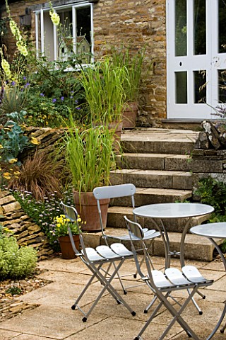 WINGWELL_NURSERY__RUTLAND_VIEW_OF_PATIO_WITH_TABLE_AND_CHAIRS_INFRONT_OF_STEPS_LEADING_TO_WHITE_DOOR