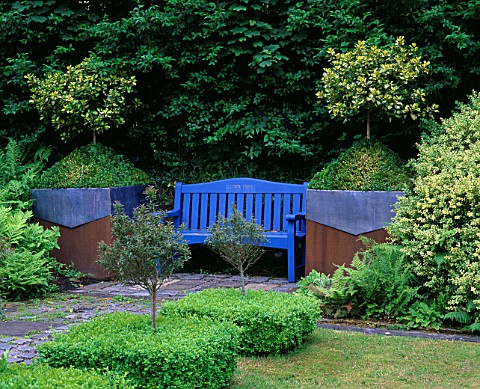 RIDLERS_GARDEN__SWANSEA__WALES_BLUE_BENCH_WITH_LEAD_AND_RUSTY_METAL_CONTAINERS_BESIDE_PLANTED_WITH_H