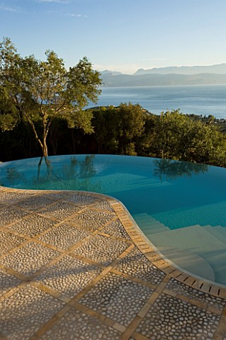 VIEW_OF_THE_ALBANIAN_MOUNTAINS_FROM_THE_TERRACE_WITH_AN_OLIVE_TREE_AND_INFINITY_SWIMMING_POOL_IN_THE
