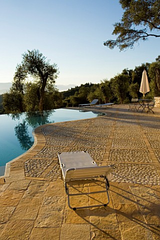 VIEW_OF_THE_ALBANIAN_MOUNTAINS_FROM_THE_TERRACE_WITH_AN_OLIVE_TREE_AND_INFINITY_SWIMMING_POOL_IN_THE