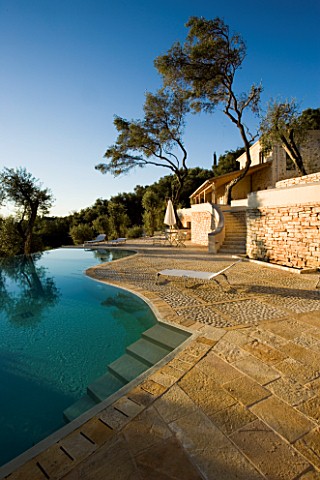 VIEW_OF_THE_HOUSE_WITH__OLIVE_TREES_AND_INFINITY_SWIMMING_POOL_IN_THE_FOREGROUND_GINA_PRICES_GARDEN_