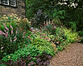 MAYROYD MILL HOUSE  YORKSHIRE. DESIGNERS RICHARD EASTON AND STEVE MACKAY. LATE SUMMER PERENNIAL BORDER BY THE HOUSE