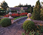LADY FARM  SOMERSET: PATH BY THE TERRACE WITH STONE BALLS  BOX BALLS AND DAHLIA BISHOP OF LLANDAF IN THE EVENING