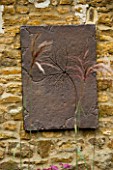RICKYARD BARN GARDEN  NORTHAMPTONSHIRE: DESIGNERS CLIVE AND JANE NICHOLS: WALL MOUNTED PICTURE OF BRONZE LEAF BY GREEN INTERIORS