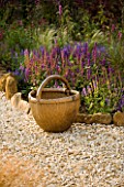 RICKYARD BARN GARDEN  NORTHAMPTONSHIRE: OLD CHINESE WICKER BASKET BESIDE A BORDER WITH SALVIAS IN THE GRAVEL GARDEN