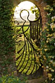 BIRTSMORTON COURT  WORCESTERSHIRE: THE ANGEL GATE IN THE WALLED GARDEN LOOKING OVER THE MALVERN HILLS. MADE BY MIKE ROBERTS