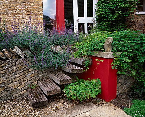 WINGWELL_NURSERY__RUTLAND_WOODEN_STEPS_AT_THE_BACK_OF_THE_HOUSE_LEADING_UP_TO_RED_WALL