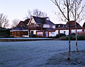 GARDEN DESIGNED BY DUNCAN HEATHER: THE HOUSE SEEN FROM ACROSS THE FROSTY LAWN
