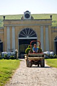 BELLAMONT TOPIARY  DORSET: EYRE SYKES DRIVES A TRACTOR IN FRONT OF THE BARN