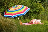 DESIGNER CLARE MATTHEWS: PARASOL WITH PINK BLANKET  HAT  BOOK AND CUSHIONS