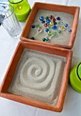 DESIGNER: CLARE MATTHEWS - ZEN TRAY PROJECT - SAND TRAYS WITH MARBLES ON TABLE