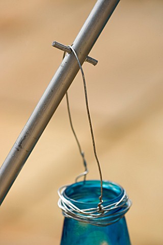 DESIGNER_CLARE_MATTHEWS_LANTERN_STAND_PROJECT_SILVER_WOODEN_ROD_WITH_BLUE_GLASS_CANDLE_JAR