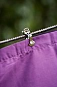 DESIGNER: CLARE MATTHEWS - CURTAINED BENCH PROJECT - CLOSE UP OF CLIP ON PURPLE FABRIC