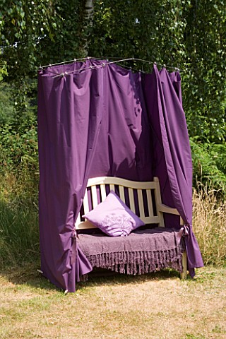 DESIGNER_CLARE_MATTHEWS__CURTAINED_BENCH_PROJECT__FINISHED_BENCH_SURROUNDED_BY_A_PURPLE_CURTAIN