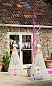 DESIGNER CLARE MATTHEWS: CHILDRENS PARTY - HANGING COCOONS ON PATIO WITH CUSHION AND BUNTING