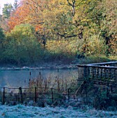 THE LAKE AND THE BALUSTRADED STONE WALL OF THE GREAT LAWN. PARNHAM HOUSE GARDEN  DORSET