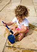 DESIGNER CLARE MATTHEWS: WATER PAINTING - GIRL PAINTING PATIO WITH WATER