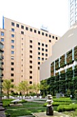 MARUNOUCHI HOTEL  TOKYO. GRANITE SCULPTURES ON STONE PEDESTALS WITH VERTICAL GARDEN ON WALL. ROOF GARDEN. MODERN. DESIGNER (ARCHITECT): MITSUBISHI JISHO SEKKEI INC.