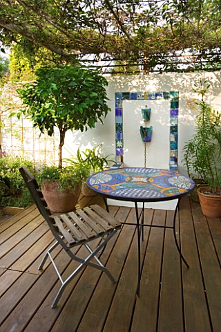 MEDITERRANEAN_DECKED_COURTYARD_WITH_STANDARD_BAY__TILED_WATER_FEATURE_AND_MOSAIC_TABLE_SHADE_CANOPY_