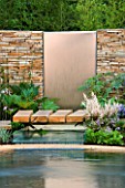 HAMPTON COURT FLOWER SHOW 2006: DESIGNER - PAUL MARTIN: DRY STONE WALL WITH METAL WATER FEATURE WITH FOUNTAIN