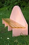 VEDDW HOUSE GARDEN  GWENT  WALES: DESIGNERS ANNE WAREHAM AND CHARLES HAWES - PINK SEAT/ BENCH ABOVE THE GRASSSES PARTERRE