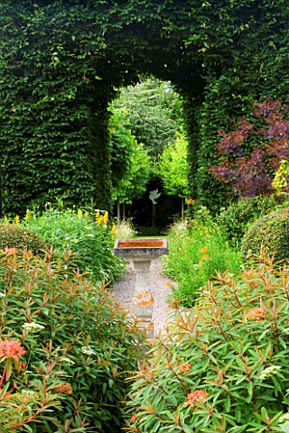 VEDDW_HOUSE_GARDEN__GWENT__WALES_DESIGNERS_ANNE_WAREHAM_AND_CHARLES_HAWES__VIEW_THOUGH_HORNBEAM_TUNN