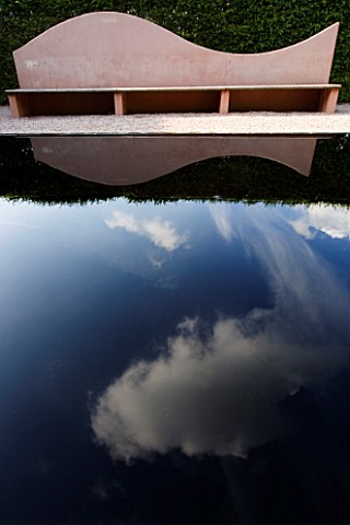 VEDDW_HOUSE_GARDEN__GWENT__WALES_DESIGNERS_ANNE_WAREHAM_AND_CHARLES_HAWES__PINK_SEAT_BENCH_REFLECTED