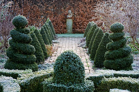 WOODPECKERS__WARWICKSHIRE__WINTER_FORMAL_GARDEN_IN_FROST_WITH_KNOT_GARDEN__TWISTED_TOPIARY_SHAPES___