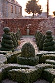 WOODPECKERS  WARWICKSHIRE  WINTER: FORMAL GARDEN IN FROST WITH KNOT GARDEN  TWISTED TOPIARY SHAPES   BRICK PATH  STATUE AND BEECH HEDGE