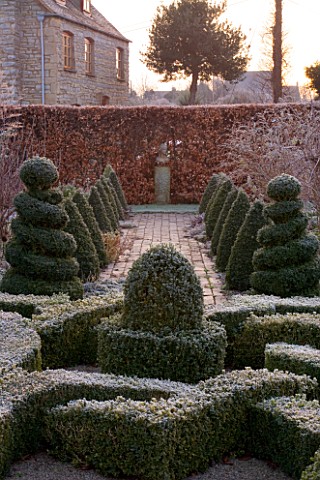 WOODPECKERS__WARWICKSHIRE__WINTER_FORMAL_GARDEN_IN_FROST_WITH_KNOT_GARDEN__TWISTED_TOPIARY_SHAPES___