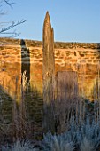 RICKYARD BARN GARDEN  NORTHAMPTONSHIRE - WINTER - THE GARDEN IN FROST AT DAWN WITH DRIFTWOOD SCULPTURE