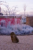 RICKYARD BARN GARDEN  NORTHAMPTONSHIRE - WINTER - THE GARDEN IN FROST AT DAWN WITH ROCK AND WALL PAINTED RED