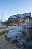 RICKYARD BARN GARDEN  NORTHAMPTONSHIRE - WINTER - THE GARDEN IN FROST AT DAWN WITH THE BARN BEHIND