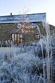RICKYARD BARN GARDEN  NORTHAMPTONSHIRE - WINTER - THE GARDEN IN FROST AT DAWN WITH THE BARN BEHIND