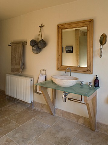 BOONSHILL_FARM__EAST_SUSSEX_INTERIOR_OF_BATHROOM_WITH_STONE_FLOOR_AND_SINKBASIN_DESIGNED_BY_LISETTE_