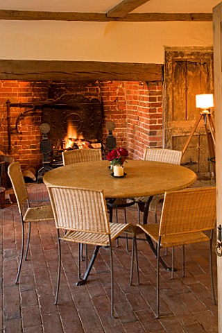 BOONSHILL_FARM__EAST_SUSSEX_INTERIOR_OF_KITCHEN_WITH_INGLENOOK_FIREPLACE__TABLE_AND_CHAIRS__TRIPOD_L