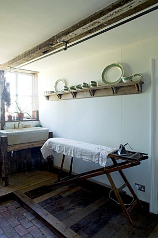 BOONSHILL_FARM__EAST_SUSSEX_INTERIOR_OF_PANTRY_WITH_OLD_SINK_FOUND_IN_GARDEN_WITH_ANTIQUE_IRONING_BO