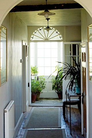 BOONSHILL_FARM__EAST_SUSSEX_INTERIOR_OF_HALLWAY_WITH_FRENCH_GLASS_LIGHTS_DESIGNER__LISETTE_PLEASANCE