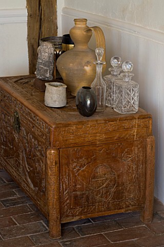 BOONSHILL_FARM__EAST_SUSSEX_ANTIQUE_CHINESE_CHEST_STANDS_ON_ORIGINAL_BRICK_FLOOR_WITH_SPANISH_POT_AN