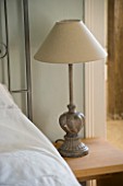 BOONSHILL FARM  EAST SUSSEX. INTERIOR OF BEDROOM WITH METAL LAMP.  DESIGNER : LISETTE PLEASANCE