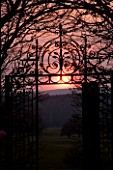 HOLKER HALL  CUMBRIA - SUNSET WITH ORNATE METAL GATE IN THE SUNKEN GARDEN