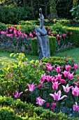 PASHLEY MANOR  EAST SUSSEX: BOX GARDEN IN SPRING WITH SCULPTURE BY HELEN SINCLAIR SURROUNDED BY TULIP MARIETTE