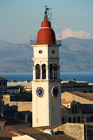 CORFU__GREECE_VIEW_OF_CORFU_TOWN_ROOFTOPS_WITH_ST_SPYRIDONS_BELLTOWER_AND_CORFU_MOUNTAINS_BEHIND